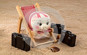 Piggy bank in a deck chair