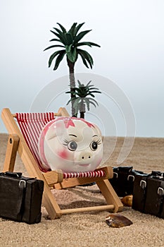 Piggy bank in a deck chair
