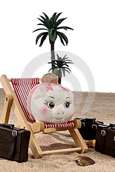 Piggy bank in a deck chair