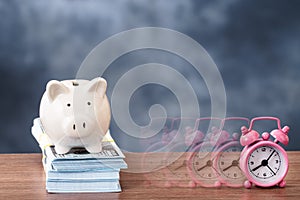 Piggy bank and disappearing alarm clock photo