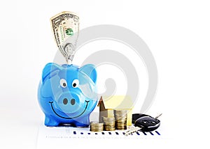 Piggy bank with dollar and coins stack and home paper and carkeys for Loans money concept Vertical