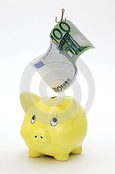 Piggy bank with Euro bill on a fishing rod