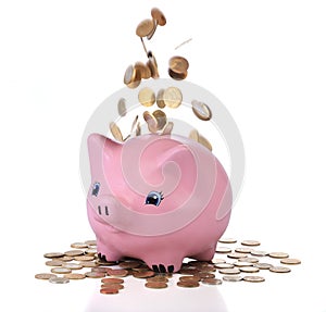 Piggy bank with falling coins