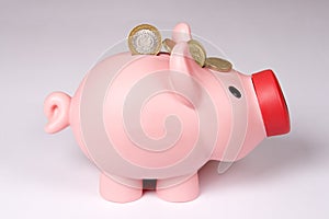 Piggy bank with few coins.