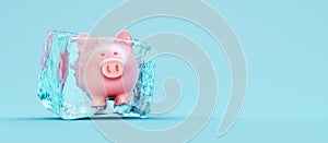 Piggy bank frozen in ice cube on blue background