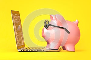 Piggy bank with glasses on laptop with stock market data on he screen. Invesment and savings concept