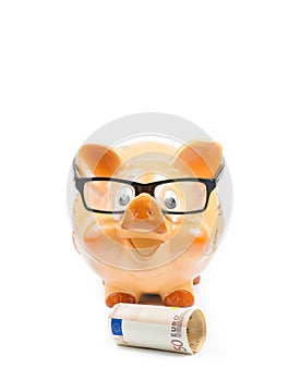 Piggy bank with glasses near fifty euro banknote, concept for business and save money