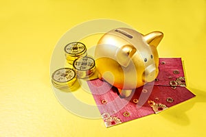 Piggy bank with golden coins and red envelopes