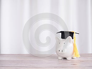 Piggy bank with graduation hat. The concept of saving money for education, student loan, scholarship, tuition fees in future