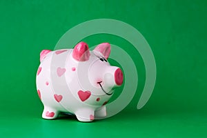 Piggy bank on green background. Copy space. Finance. Preservation.