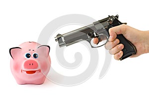 Piggy bank and hand with gun