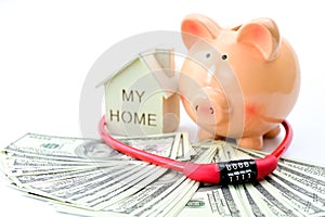 Piggy bank, home model, dollars banknotes and security padlock on white background