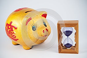 Piggy bank and hourglass
