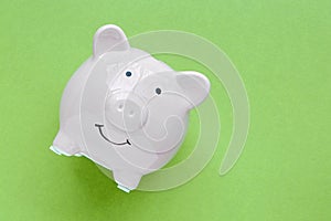 Piggy bank isolated on green background