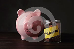 Piggy bank and jar of coins with word PENSION