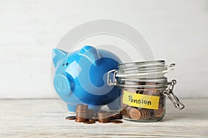 Piggy bank and jar of coins with word PENSION