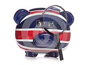 Piggy bank with magnifying glass photo