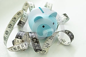 Piggy bank with measure tape.