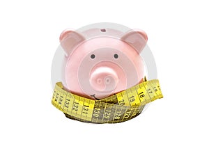 Piggy bank with measure tape on white background