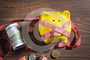 Piggy bank with measuring tape and coins