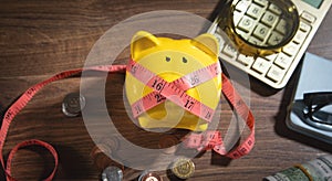 Piggy bank with measuring tape and coins