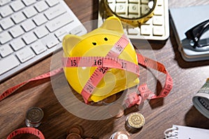 Piggy bank with measuring tape and coins