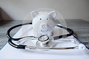 Piggy bank with medical equipment on the table medical concepts and health insurance