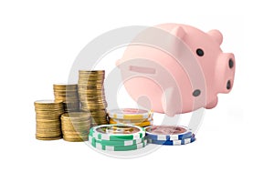 Piggy bank and money coins stack with casino chips on white background. Concept of gambling savings