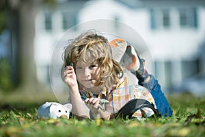 Piggy bank for money. Portrait of a little boy putting money on a moneybox. Child saving money in a piggybank on