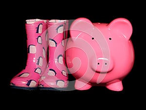 Piggy bank next to wellies