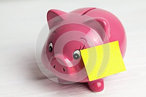 Piggy bank and paper sticker on white background. side view, closedup