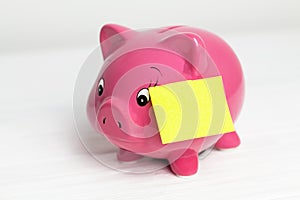 Piggy bank and paper sticker on white background. side view, closedup