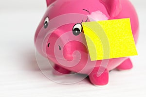 Piggy bank and paper sticker on white background. side view, closedup