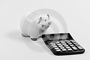 Piggy bank pig and calculator. Taxes and charges may vary. Accounting business. Taxes and fees concept. Tax savings