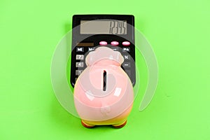 Piggy bank pig and calculator. Taxes and charges may vary. Helping make smart financial choices. Pay taxes. Taxes