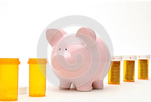 Piggy Bank and Pill Bottle Isolated on White