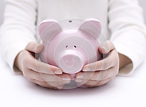 Piggy bank protected by hands photo