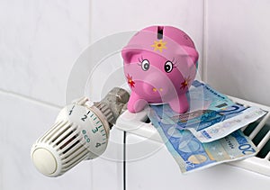 Piggy bank with radiator thermostat saving heating costs