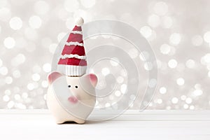 Piggy bank and santa claus hat