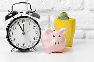 Piggy bank save coin and alarm clock, time and money concept.