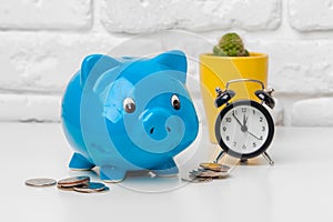 Piggy bank save coin and alarm clock, time and money concept.