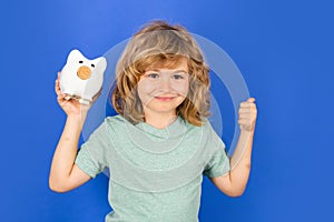 Piggy bank for saving money concept. Child boy hold piggy bank. Kid with piggybank.