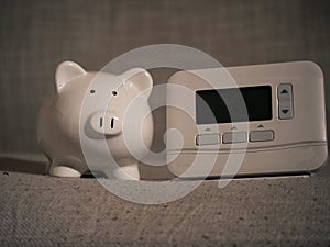 Piggy bank savings and central heating thermostat controls