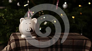 Piggy bank savings in Christmas tree background