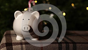 Piggy bank savings in Christmas tree background