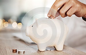 Piggy bank savings, investment and hand with money, coin or silver investing in future wealth, financial growth or