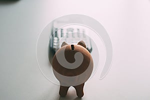 Piggy bank shaped piggy bank in front of calculator. Economy and finances of the home