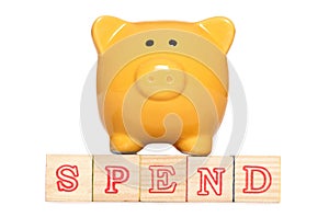 Piggy bank with spend alphabet blocks photo