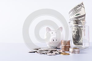 Piggy bank with stack coins and money paper inside jar isolated grey background. Property investment and house mortgage financial