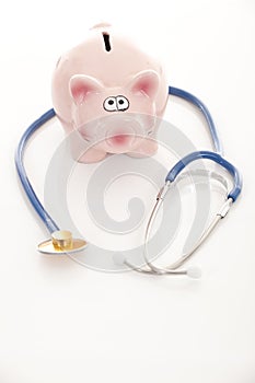Piggy bank and stethoscope